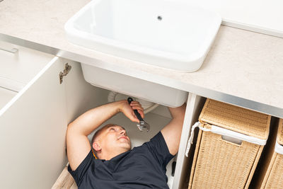 High angle view of woman washing hands in bathroom