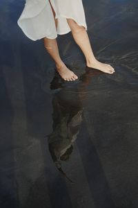 Low section of woman standing on beach