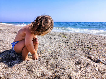 Full length of boy on beach against sky