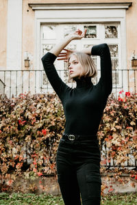 Full length of woman standing in front of building