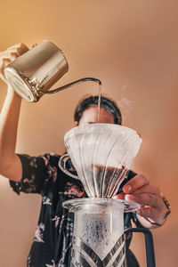 Close-up of hand pouring tea