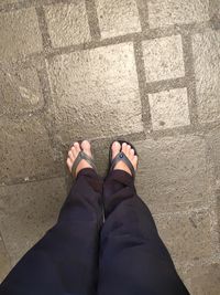 Low section of woman standing on tiled floor