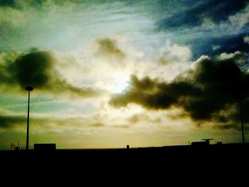 Silhouette landscape against dramatic sky