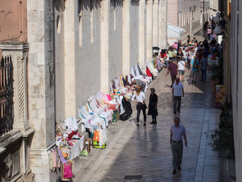 People walking on narrow street in city