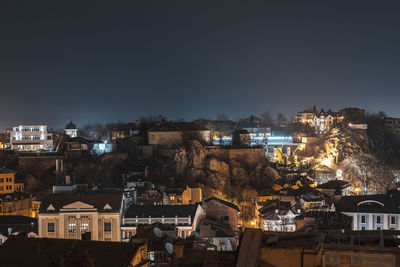 High angle view of illuminated buildings in city at night