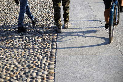Low section of people walking on road