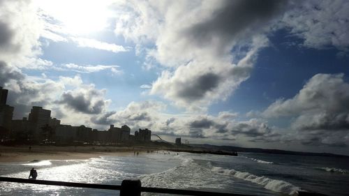 Panoramic view of buildings by sea against sky