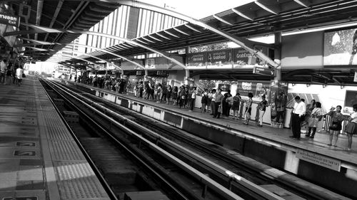 People waiting at railroad station platform