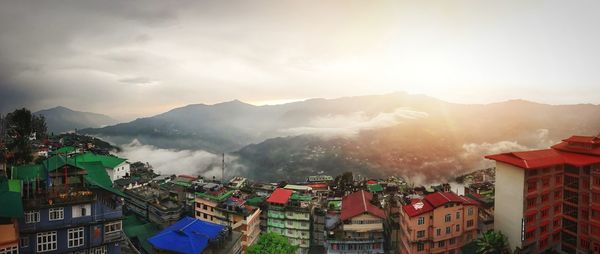 Panoramic view of buildings in city against sky during sunset