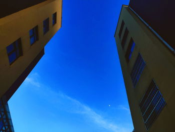 Low angle view of buildings against clear blue sky