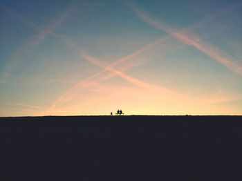 Silhouette man against sky at sunset