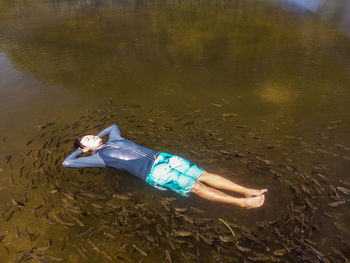 High angle view of boy swimming in lake