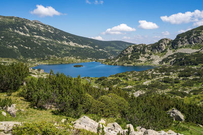 Scenic view of lake and mountains against sky