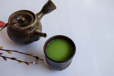 High angle view of tea cup against white background