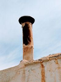 Low angle view of old wall against sky