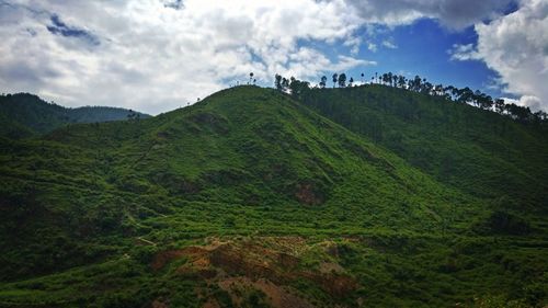 Scenic view of field and mountains against sky