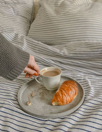 Coffee cup on bed