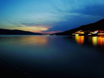 Scenic view of lake against sky at sunset