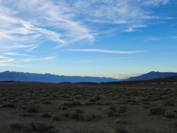 Scenic view of mountains against blue sky