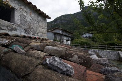 Houses by rocks against sky