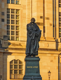 Statue in front of historical building