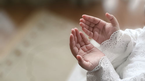 Cropped image of couple holding hands