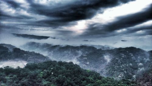 Scenic view of landscape against cloudy sky