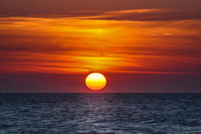 Scenic view of sea against orange sky