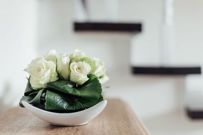 Close-up of white rose on table at home