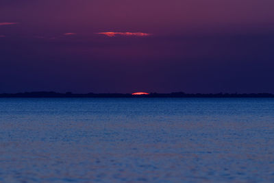 Scenic view of sea against romantic sky at sunset