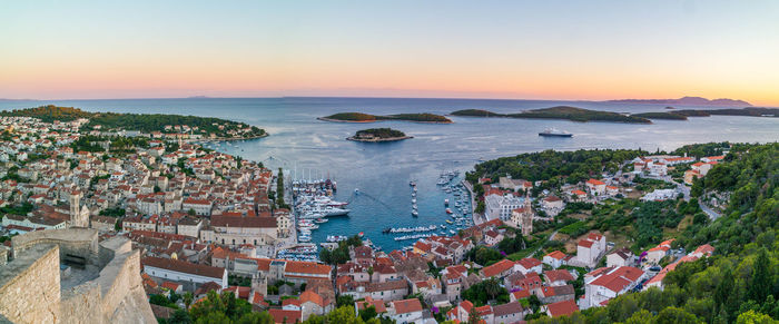 High angle view of townscape by sea against sky