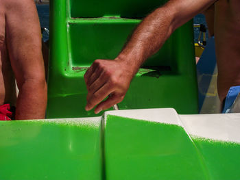 Cropped hand of man holding handle in motorboat