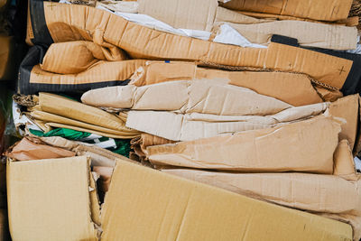 Recycled paper and paperboard for recycling in a factory