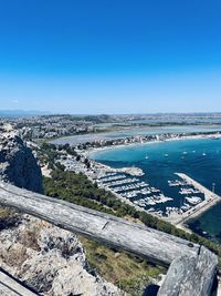 High angle view of land against clear blue sky