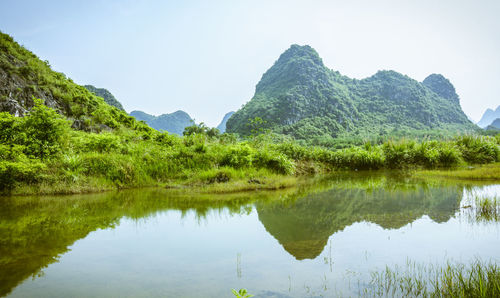 Scenic view of lake and mountains against sky