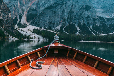 Boat on lake against mountain during winter