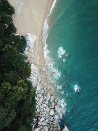 Aerial view of rock formations by beach