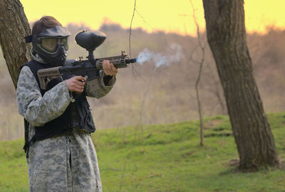 Man holding gun on field