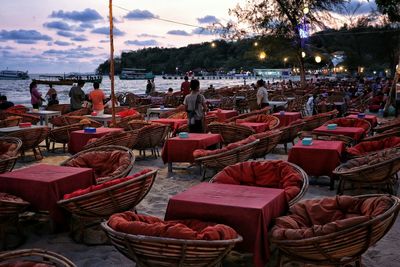 Empty chairs and tables at the shore