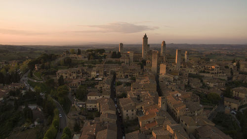 High angle view of buildings in city during sunset