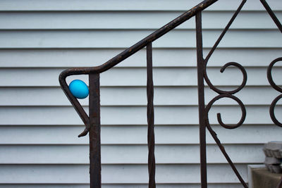 Close-up of metal fence against wall