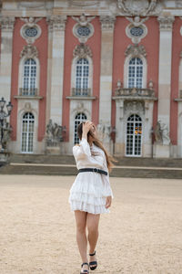 Full length of woman photographing with mobile phone