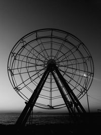 Low angle view of ferris wheel against clear sky