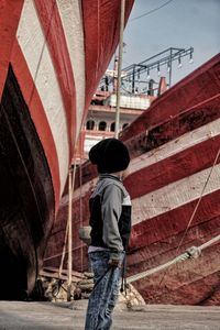 Side view of boy standing at port