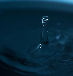 Close-up of drop falling on water surface