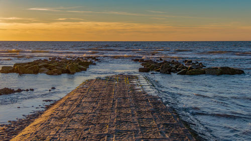 Scenic view of sea against sky at sunset