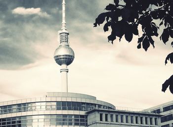 Low angle view of modern building against cloudy sky