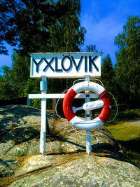 Information sign against trees