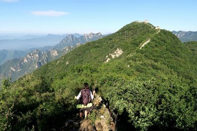 Panoramic view of people on mountain against sky