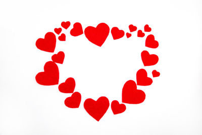 Close-up of red heart shape against white background